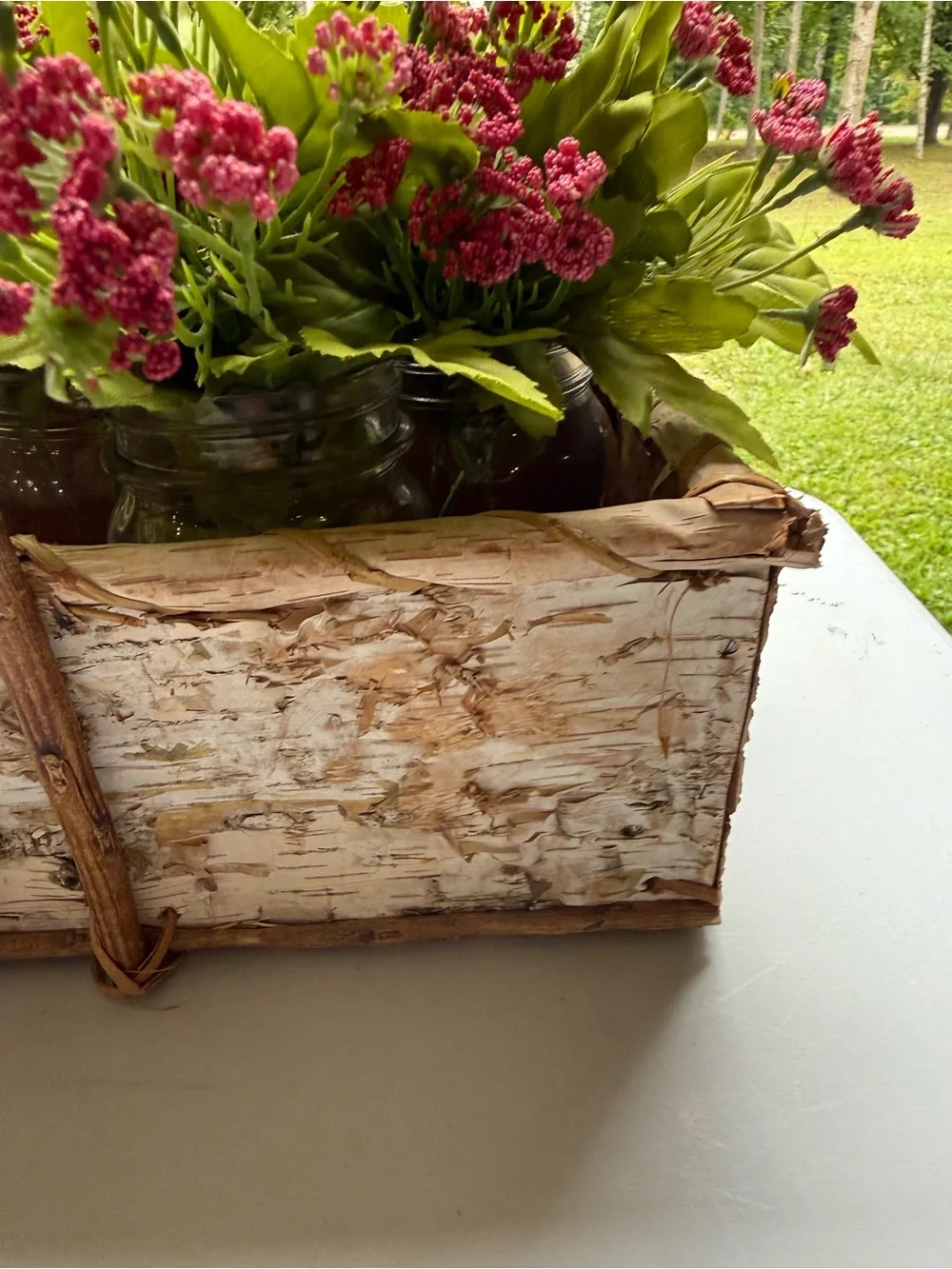 Birch basket mason jars filled with artificial flowers table decor